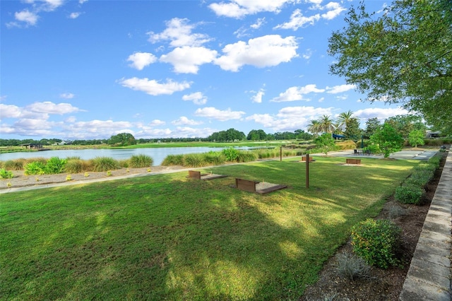 exterior space featuring a lawn and a water view