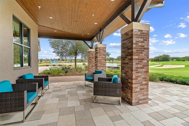 view of patio with a water view and outdoor lounge area