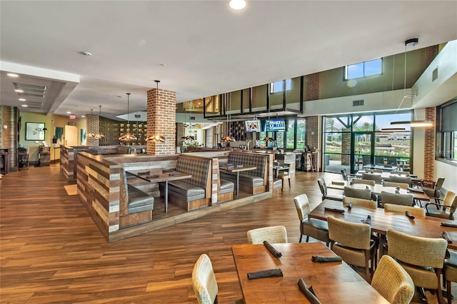 dining room featuring hardwood / wood-style flooring and a high ceiling