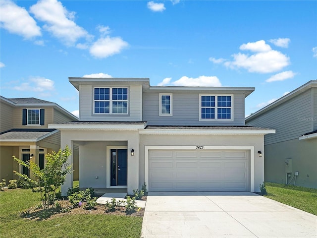 view of front property with a garage and a front lawn