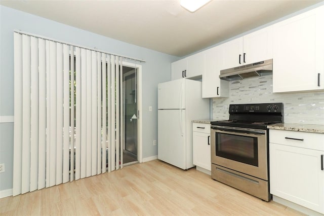 kitchen featuring freestanding refrigerator, stainless steel range with electric cooktop, under cabinet range hood, and decorative backsplash