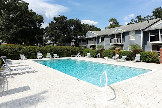 pool featuring a patio area and fence