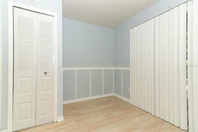 unfurnished bedroom with a closet and wood finished floors