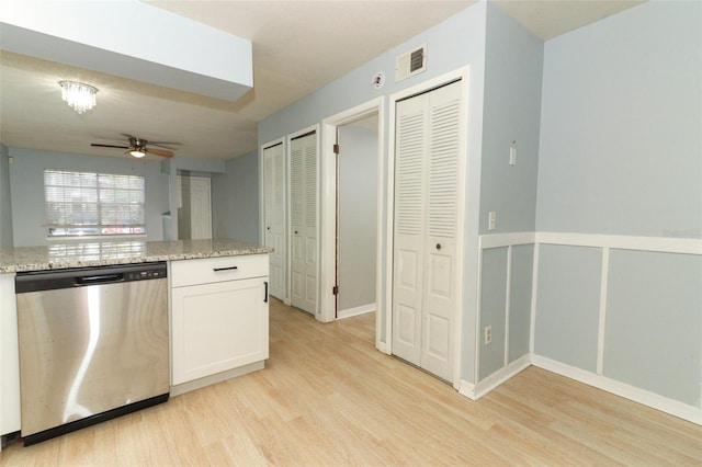 kitchen featuring visible vents, a ceiling fan, white cabinetry, light wood-style floors, and stainless steel dishwasher