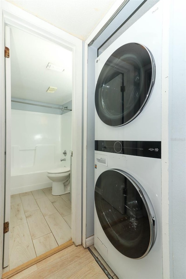 clothes washing area featuring laundry area and stacked washer / drying machine