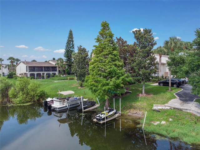 dock area with a yard and a water view