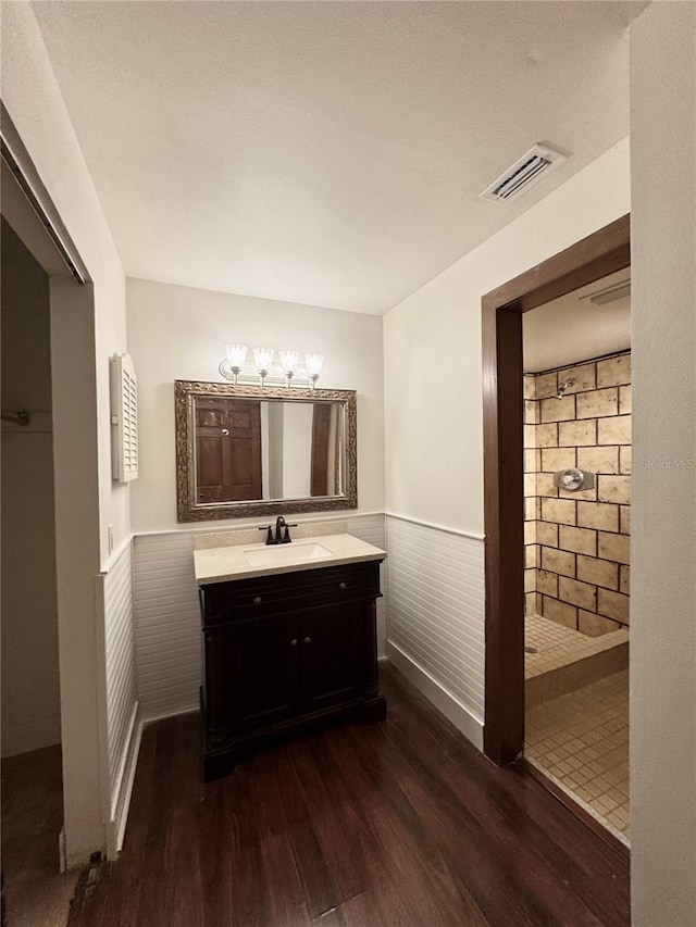 bathroom featuring wood walls, vanity, and wood-type flooring