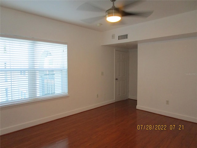 unfurnished room featuring ceiling fan and dark hardwood / wood-style floors