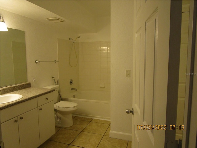 full bathroom with tile patterned flooring, vanity, toilet, and tiled shower / bath combo