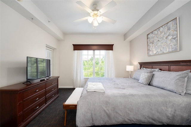 bedroom featuring ceiling fan and dark carpet