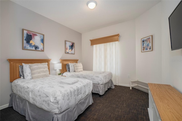 bedroom with dark colored carpet