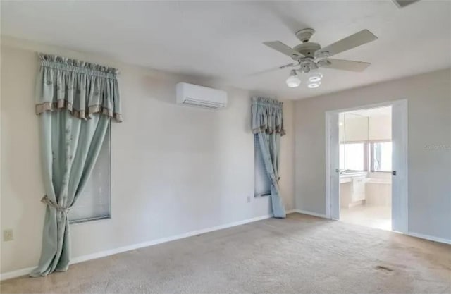 carpeted spare room featuring a wall mounted air conditioner and ceiling fan