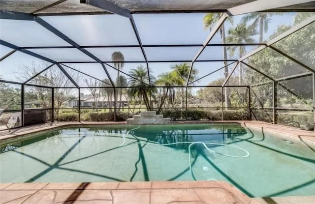 view of swimming pool with a lanai