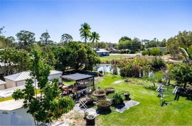 surrounding community featuring a yard and a water view