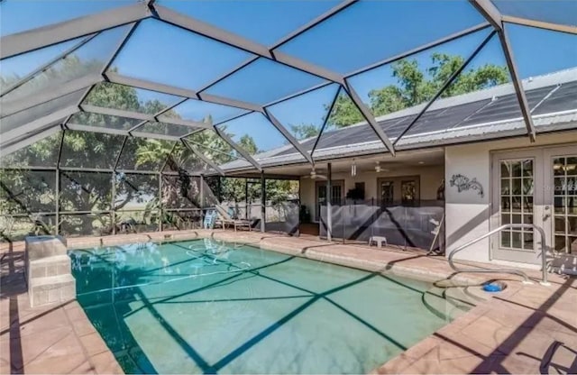 view of pool featuring a patio area, ceiling fan, and glass enclosure