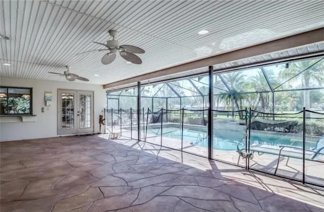 view of swimming pool featuring ceiling fan and french doors