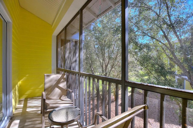 unfurnished sunroom with a healthy amount of sunlight and lofted ceiling