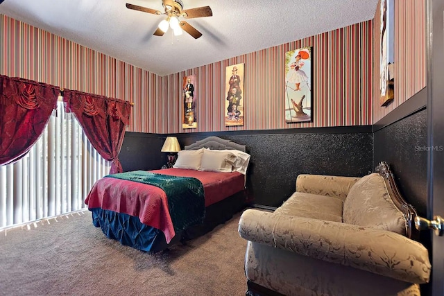 carpeted bedroom featuring a textured ceiling and ceiling fan