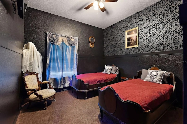 carpeted bedroom featuring a textured ceiling and ceiling fan