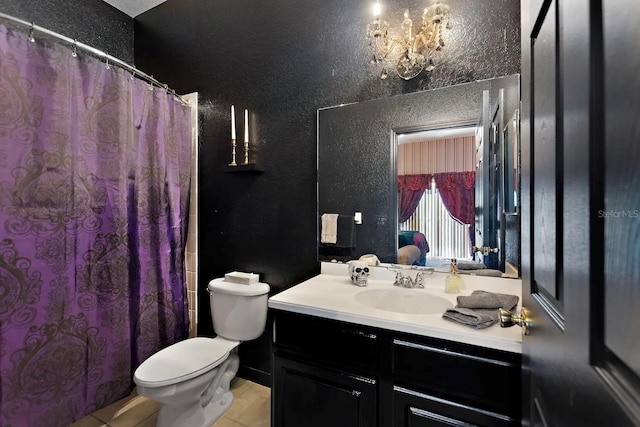 bathroom featuring tile patterned floors, vanity, a notable chandelier, and toilet