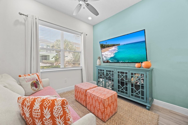 living area featuring hardwood / wood-style flooring and ceiling fan