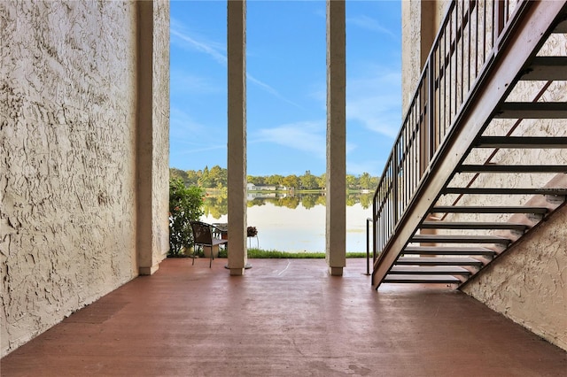 exterior space featuring a water view and dark hardwood / wood-style flooring