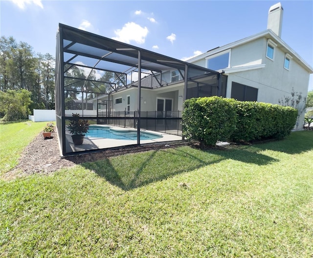 exterior space featuring a lanai and a lawn