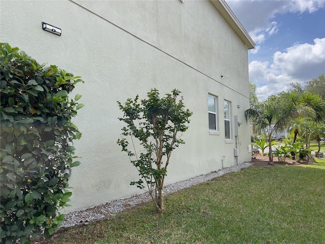 view of side of home featuring a lawn