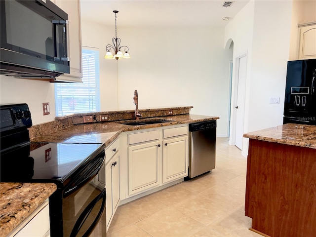 kitchen with a chandelier, black appliances, light tile patterned floors, sink, and decorative light fixtures