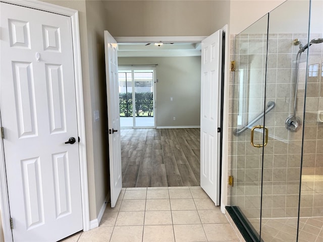 bathroom with walk in shower and tile patterned floors