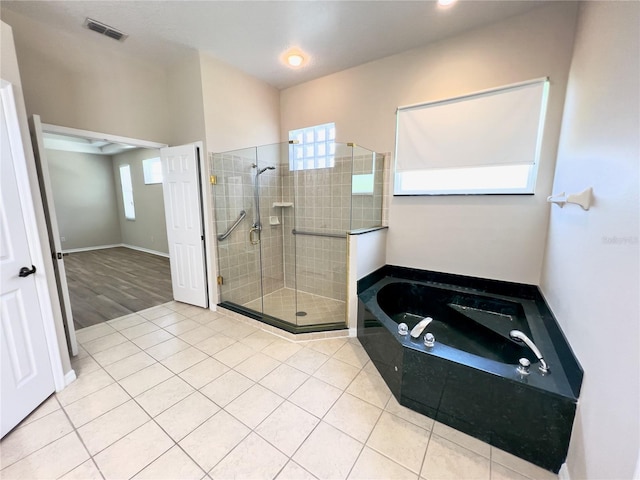 bathroom with tile patterned flooring and independent shower and bath