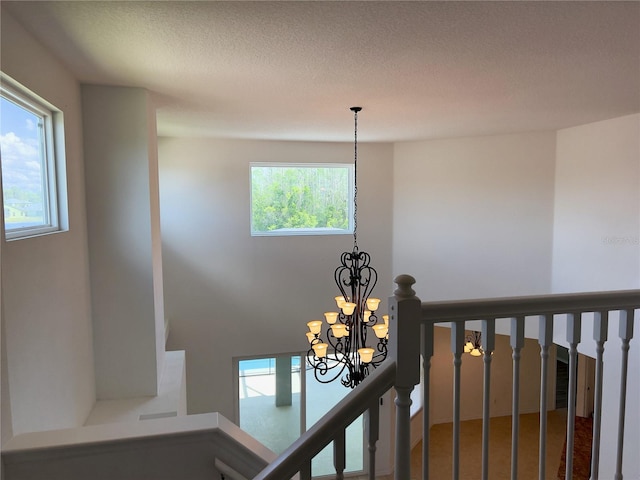 interior details with a textured ceiling and an inviting chandelier