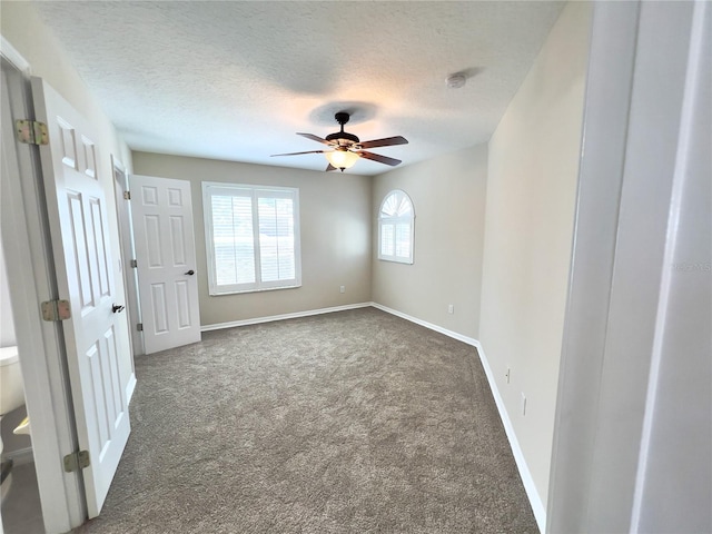 carpeted empty room featuring a textured ceiling and ceiling fan