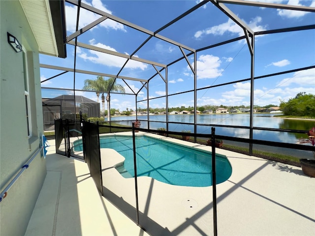 view of pool featuring a patio, glass enclosure, and a water view