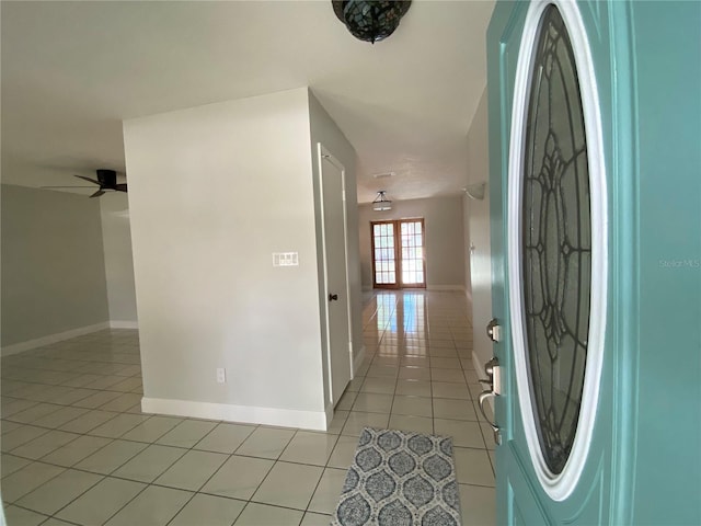 entryway with ceiling fan, light tile patterned floors, and french doors