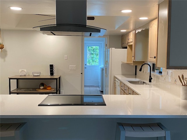 kitchen featuring dishwasher, sink, light brown cabinets, island range hood, and black electric cooktop