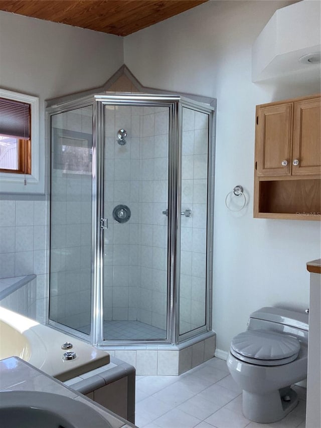 bathroom featuring toilet, tile patterned floors, and an enclosed shower