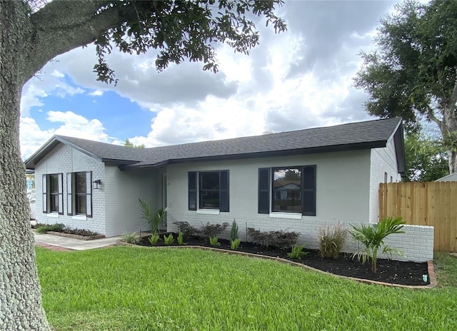 ranch-style home featuring a front yard