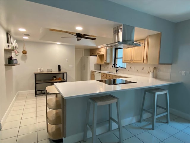 kitchen with kitchen peninsula, light brown cabinetry, white appliances, and ceiling fan