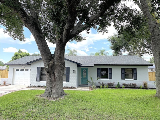 single story home with a garage and a front lawn