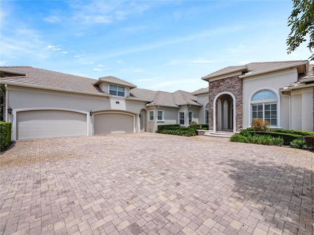 mediterranean / spanish home featuring a garage