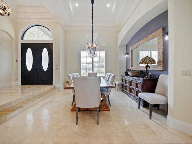 dining area with crown molding, french doors, and a notable chandelier