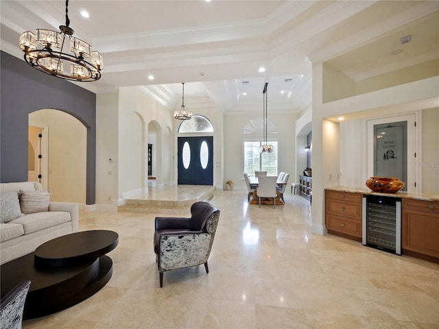 living room with wine cooler, a high ceiling, and ornamental molding