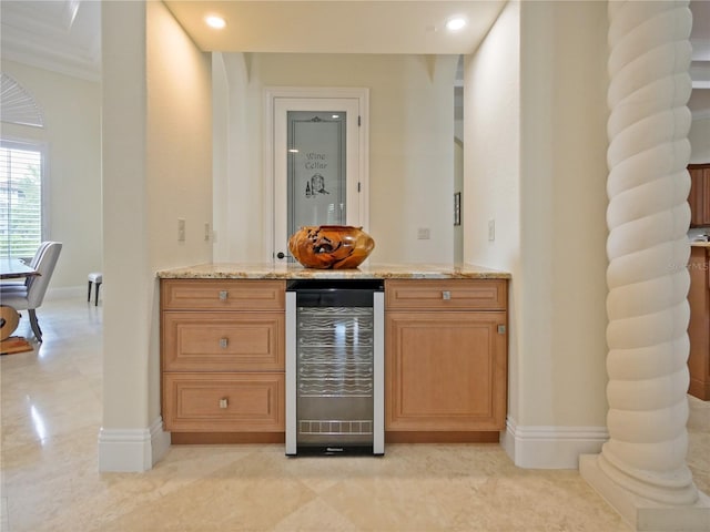 bar featuring light stone countertops, crown molding, and wine cooler