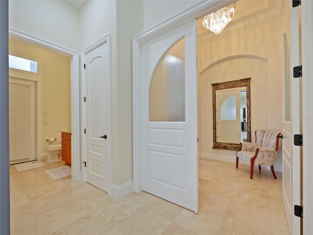 hallway featuring a notable chandelier