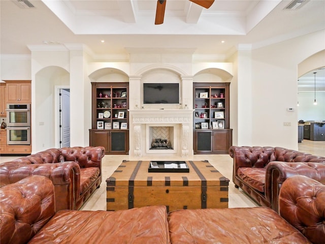 living room featuring beamed ceiling, ceiling fan, crown molding, and a high end fireplace