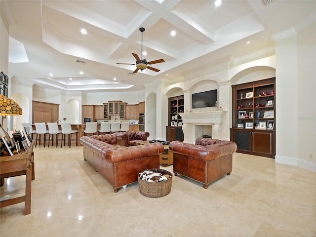 living room with beam ceiling, ceiling fan, and coffered ceiling