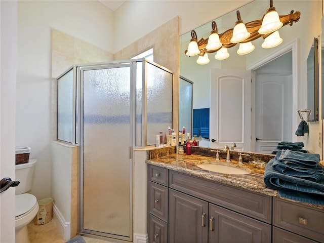 bathroom featuring vanity, toilet, and a shower with door