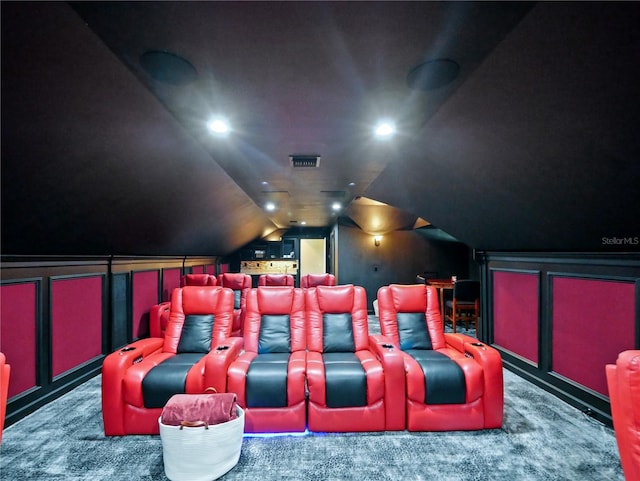 home theater room with carpet and lofted ceiling