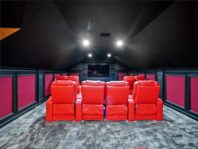 home theater with dark carpet and lofted ceiling